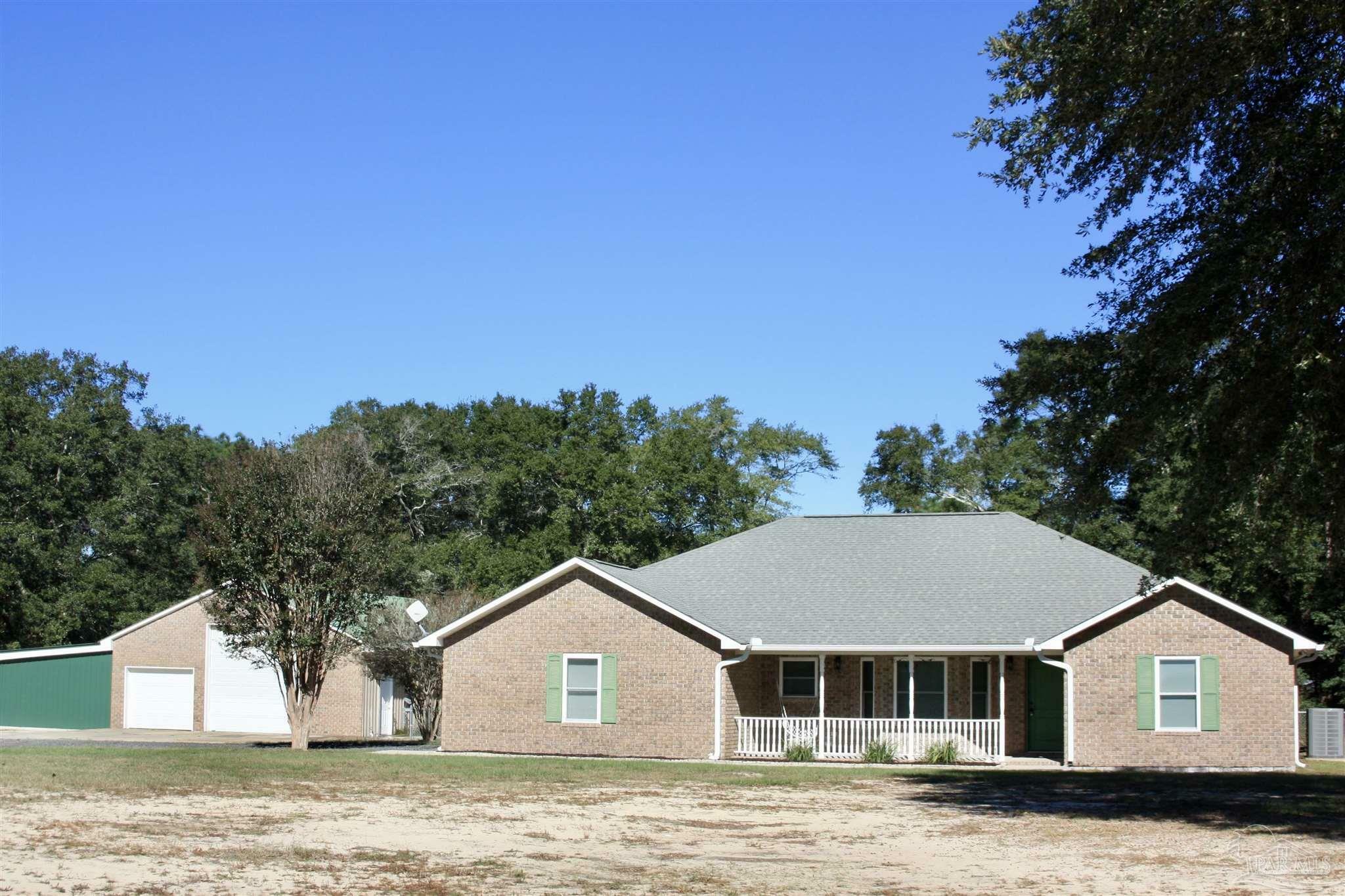 Property Photo:  5628 Pond Creek Rd  FL 32570 