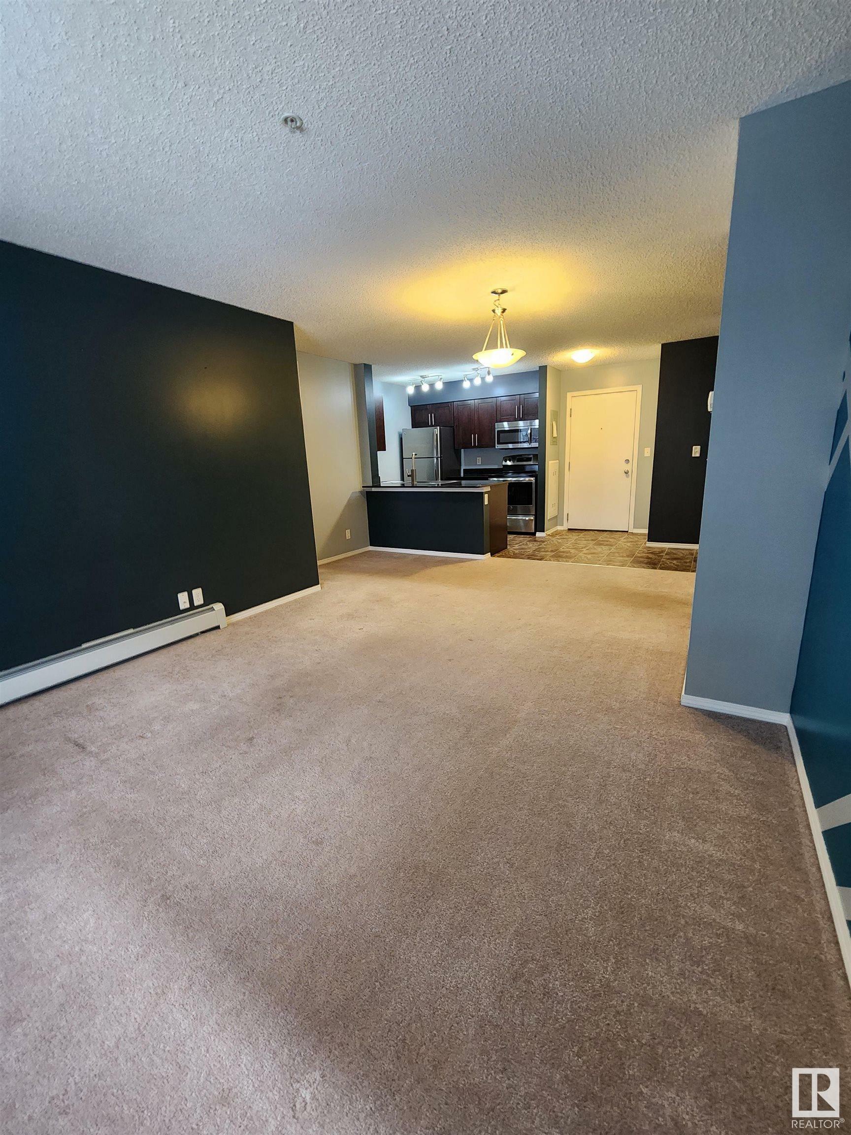 Property Photo:  12035 22 Avenue SW 218  AB T6W 2X9 