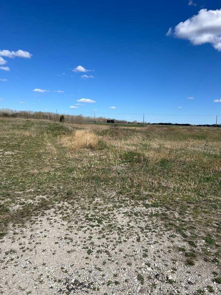 Property Photo: 275115 Glenmore Trail AB T1X 0H4