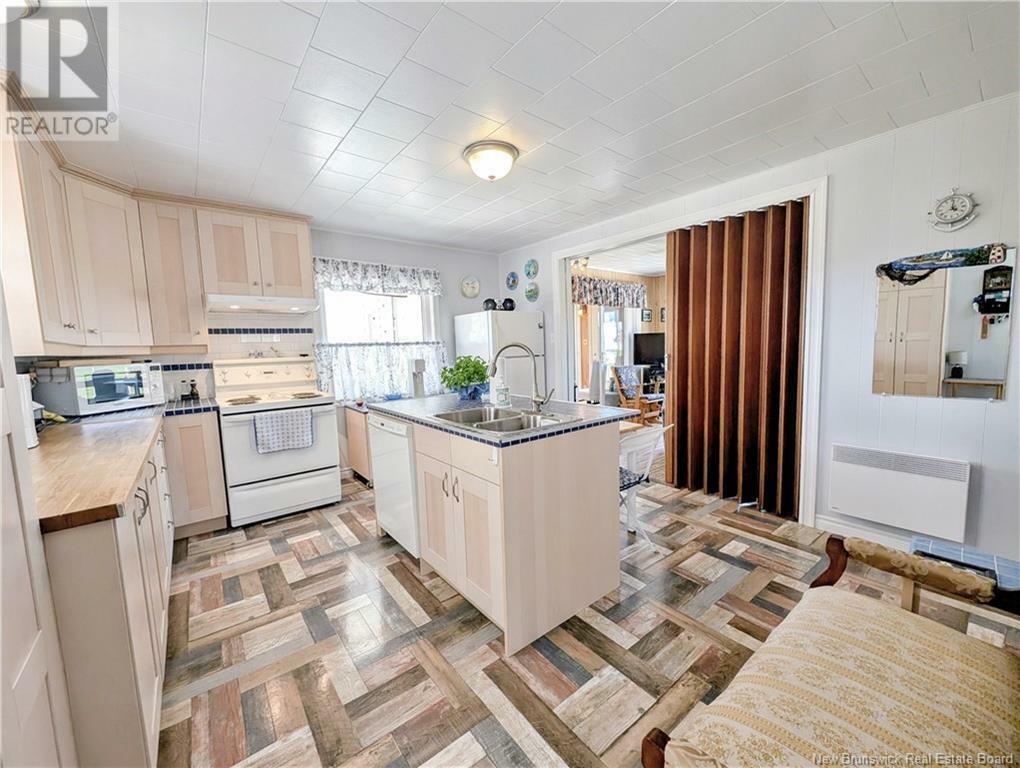 Property Photo:  506 Rue Acadie  NB E8N 1E4 