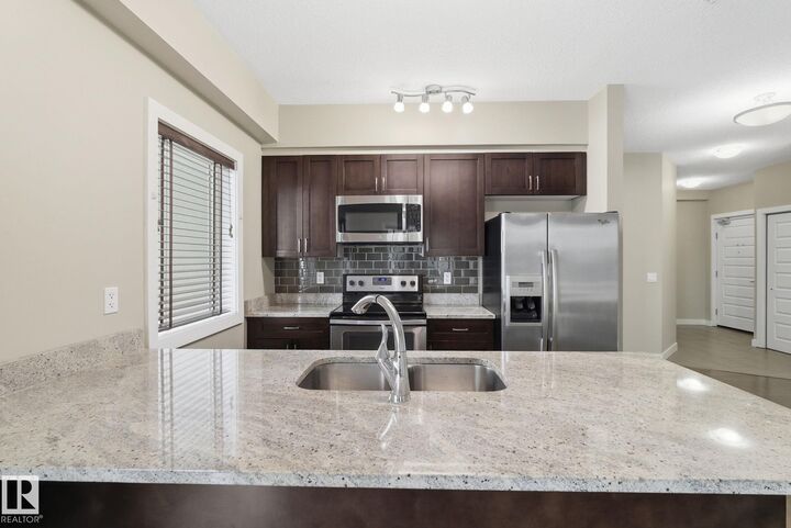 Property Photo: 1238 Windermere Way SW 214 AB T6W 2J3