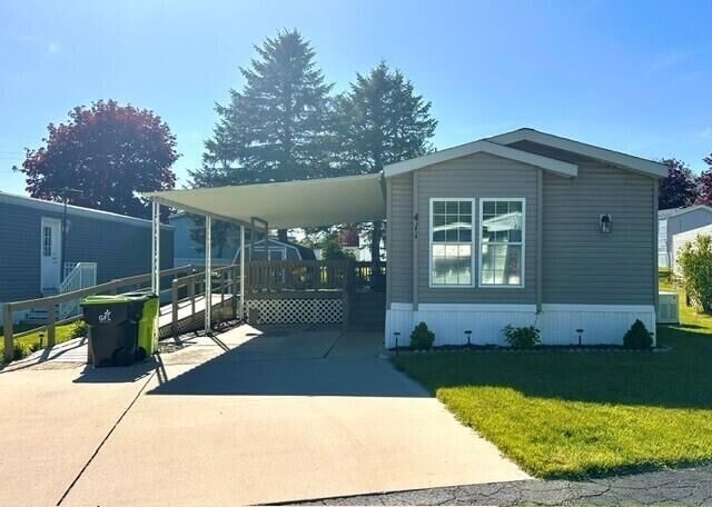 Property Photo:  411 Woodview Drive  MI 48838 