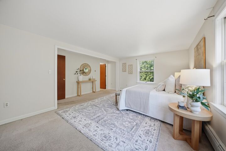 Bedroom with a large window and an adjoining room at 7 Twin Street, Windham, NH