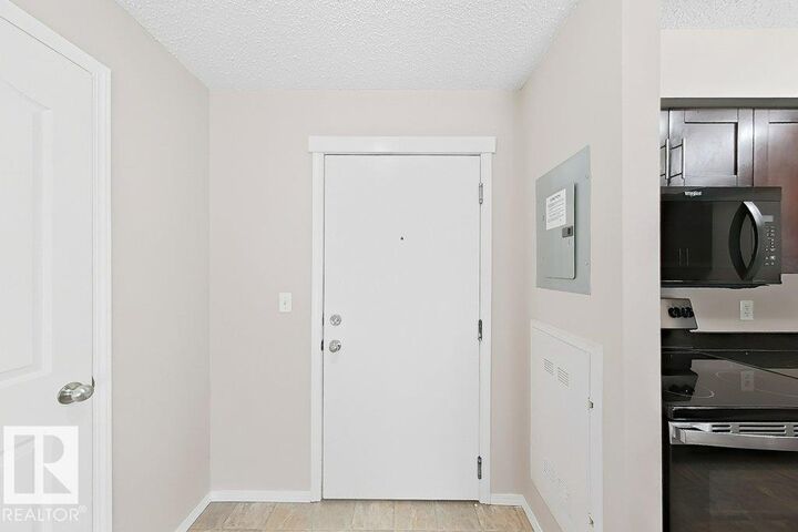 Property Photo:  12025 22 Ave SW 203  AB T6W 2Y1 