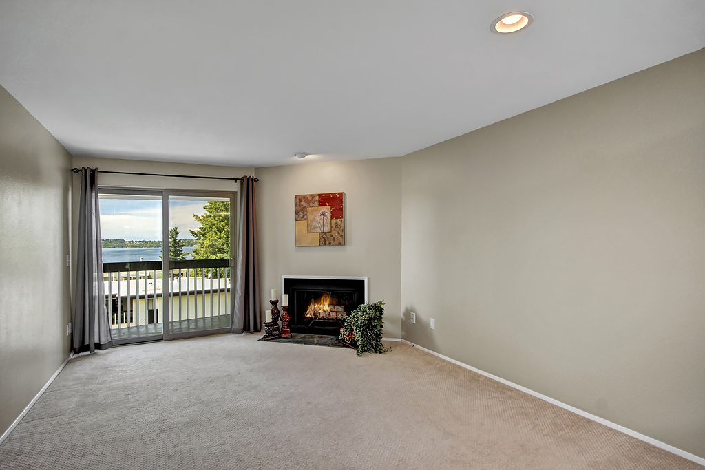Property Photo: Living room with fireplace and lake view 6627 Lakeview Dr A-302  WA 98033 