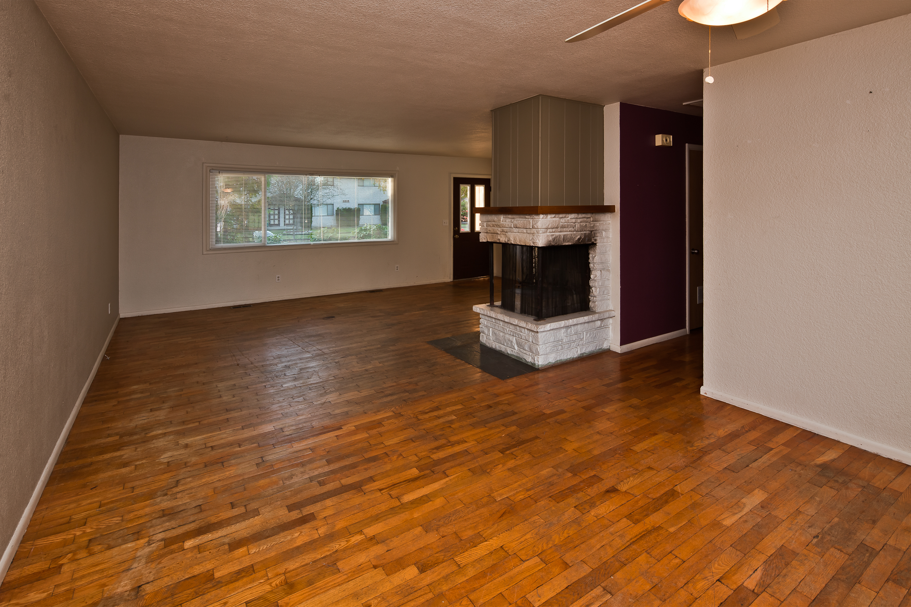 Property Photo: The view from the dining area toward the living room - with the 3-sided wood burning fireplace. 2918 Patton St  WA 98225 